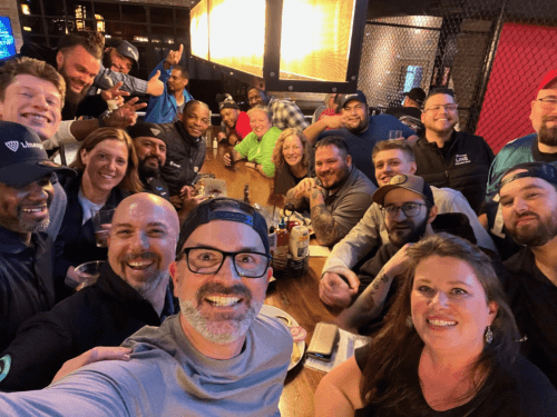 Deelnemers aan het Lineage EDGE-programma genieten van een sociale bijeenkomst in een levendig restaurant, waarbij kameraadschap en connecties buiten de werkplek worden bevorderd.
