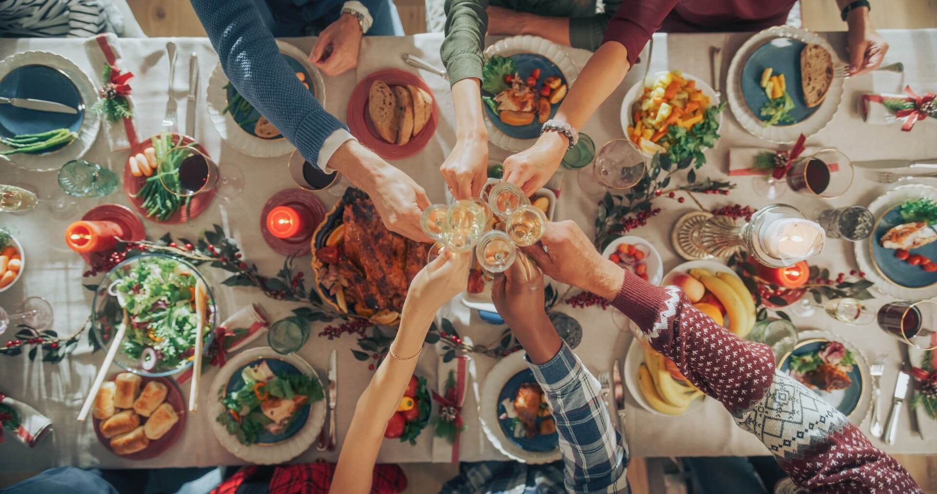 Family and friends sharing a festive meal together, representing the food supply chain that brings fresh products to the table.
