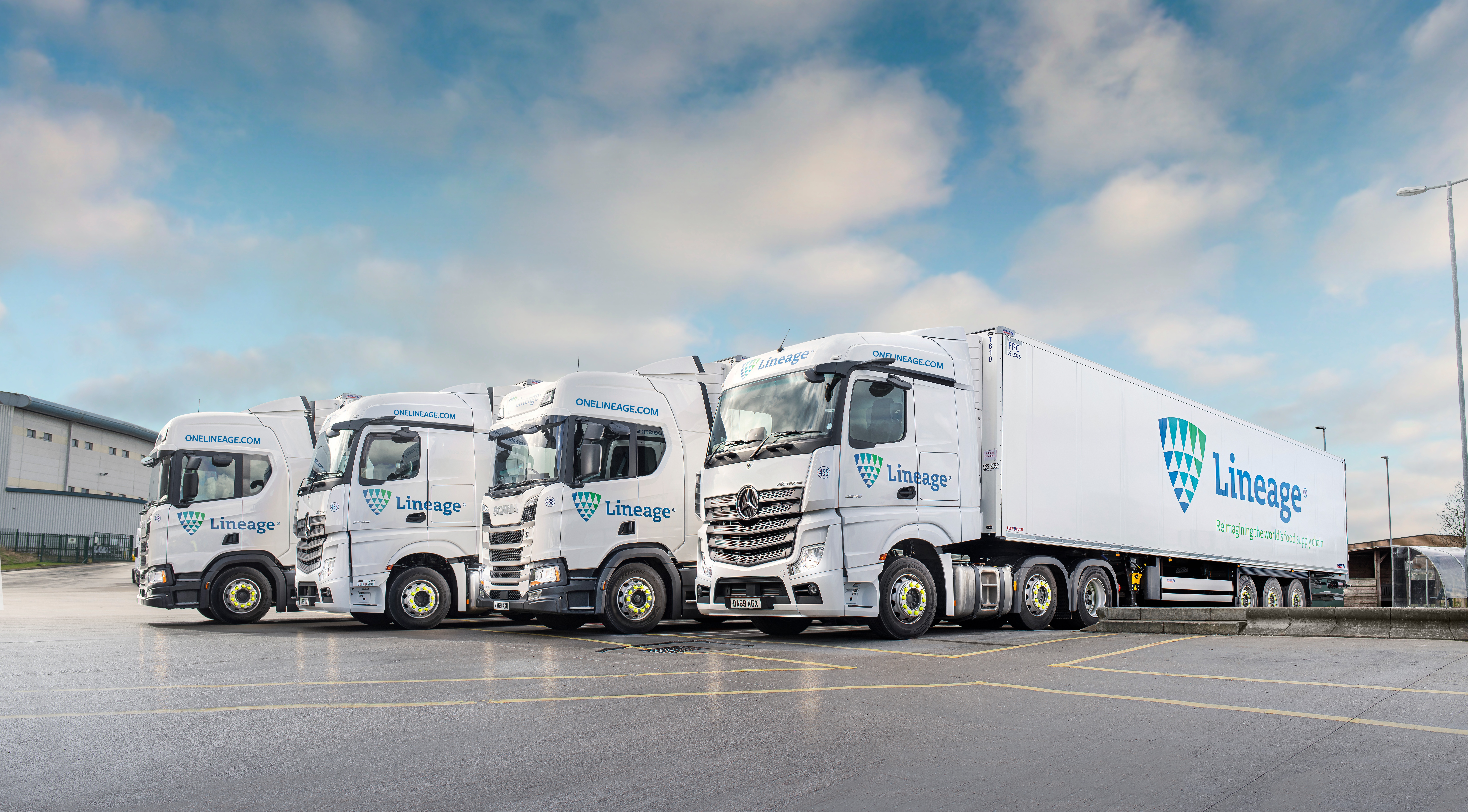 
Four Lineage logistics trucks parked in a row.