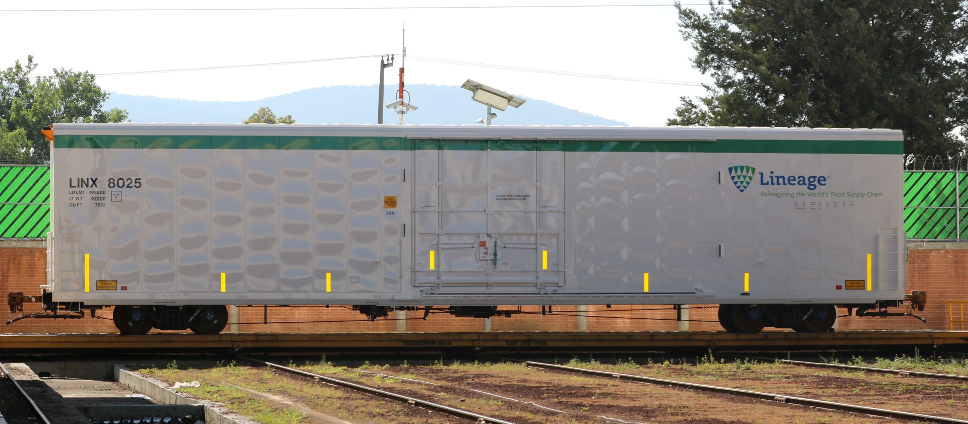 Lineage insulated railcar positioned on rail tracks, designed to help protect temperature-sensitive products during long-haul transportation.