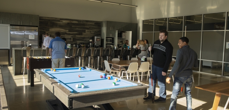 Team members relaxing and playing games in the Cooler