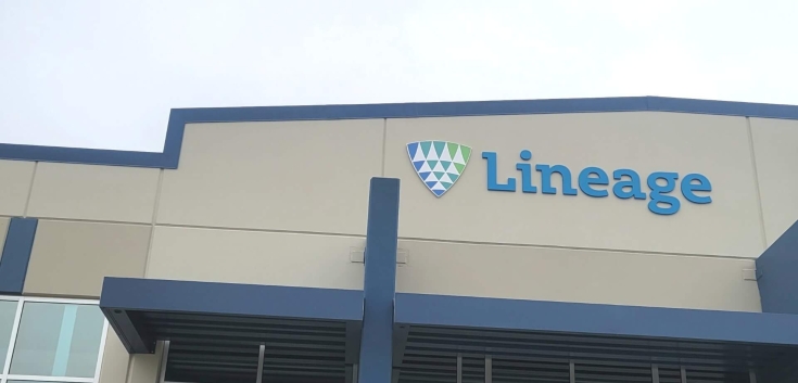 Front entrance of Lineage’s Lancaster, Texas facility, showing the blue-accented building facade, logo signage and glass entryway on an overcast day.