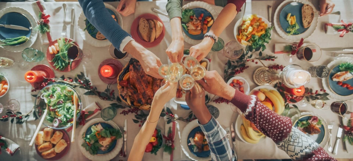 Family and friends sharing a festive meal together, representing the food supply chain that brings fresh products to the table.
