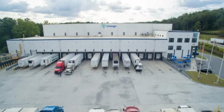 Front view of Lineage’s Lithia Springs cold storage facility in Atlanta, featuring multiple trucks docked at loading bays, emphasizing its logistics capabilities.