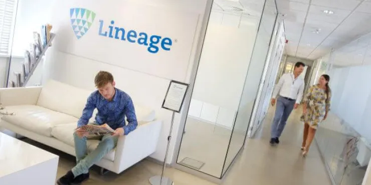 Interior of Lineage’s Bergen op Zoom office in the Netherlands with team members and branded signage in a modern reception area.