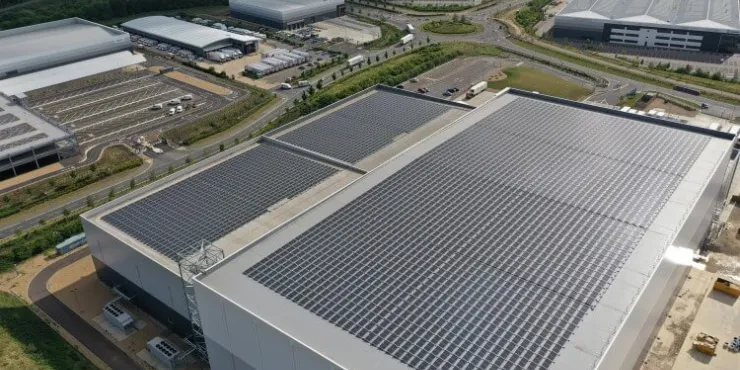 Lineage’s Peterborough cold storage facility with solar panels, loading bays, and branded trucks.