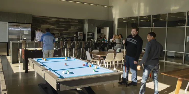 Team members relaxing and playing games in the Cooler