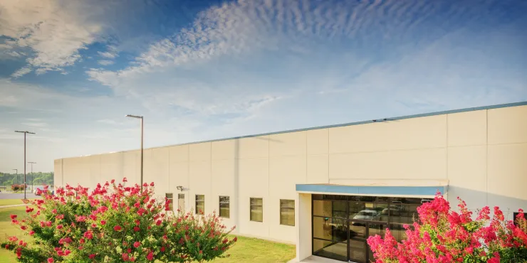 Photo of main entrance to Decatur, AL facility with flowers in bloom
