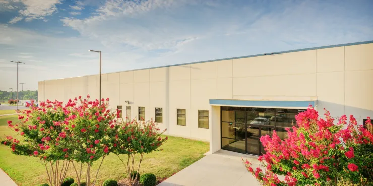 Photo of main entrance to Decatur, AL facility with flowers in bloom