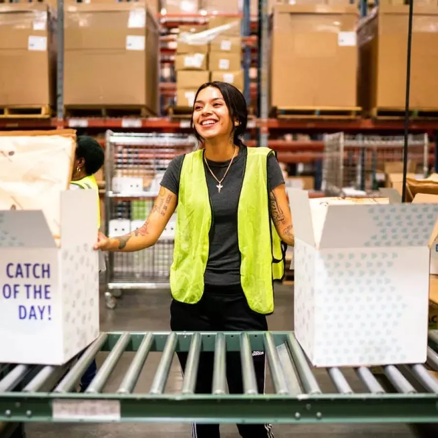 Lineage team member packing up individual orders for Direct to Consumer fulfillment.