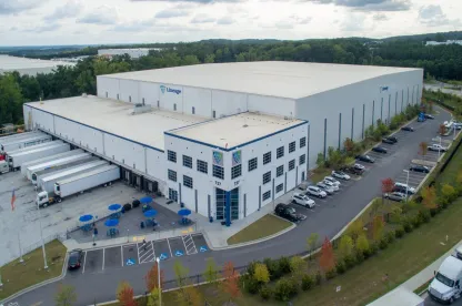 Exterior view of Lineage’s Lithia Springs cold storage facility in Atlanta, showcasing a modern warehouse design with multiple loading docks and parking areas.