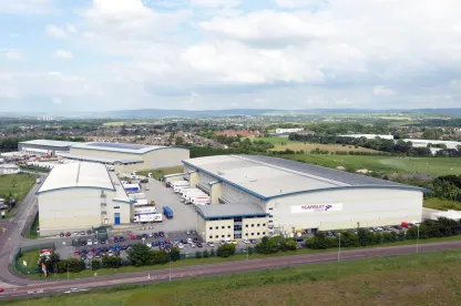 Aerial view of Lineage’s automated cold storage warehouse in Heywood, UK, with Yearsley Group trucks and multiple buildings across a large logistics site.