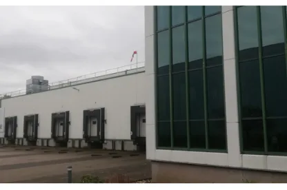 Exterior view of a facility in Venlo, featuring large windows and loading docks.